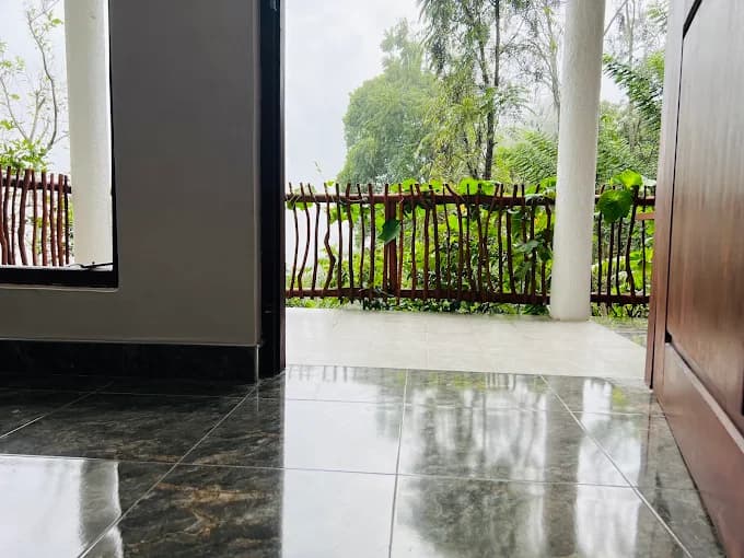 Tiled balcony looking out through a rustic wooden railing