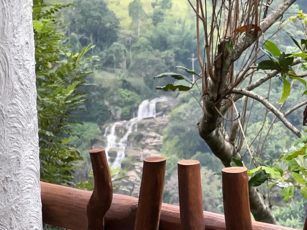 Private balcony looking out over a forest waterfall