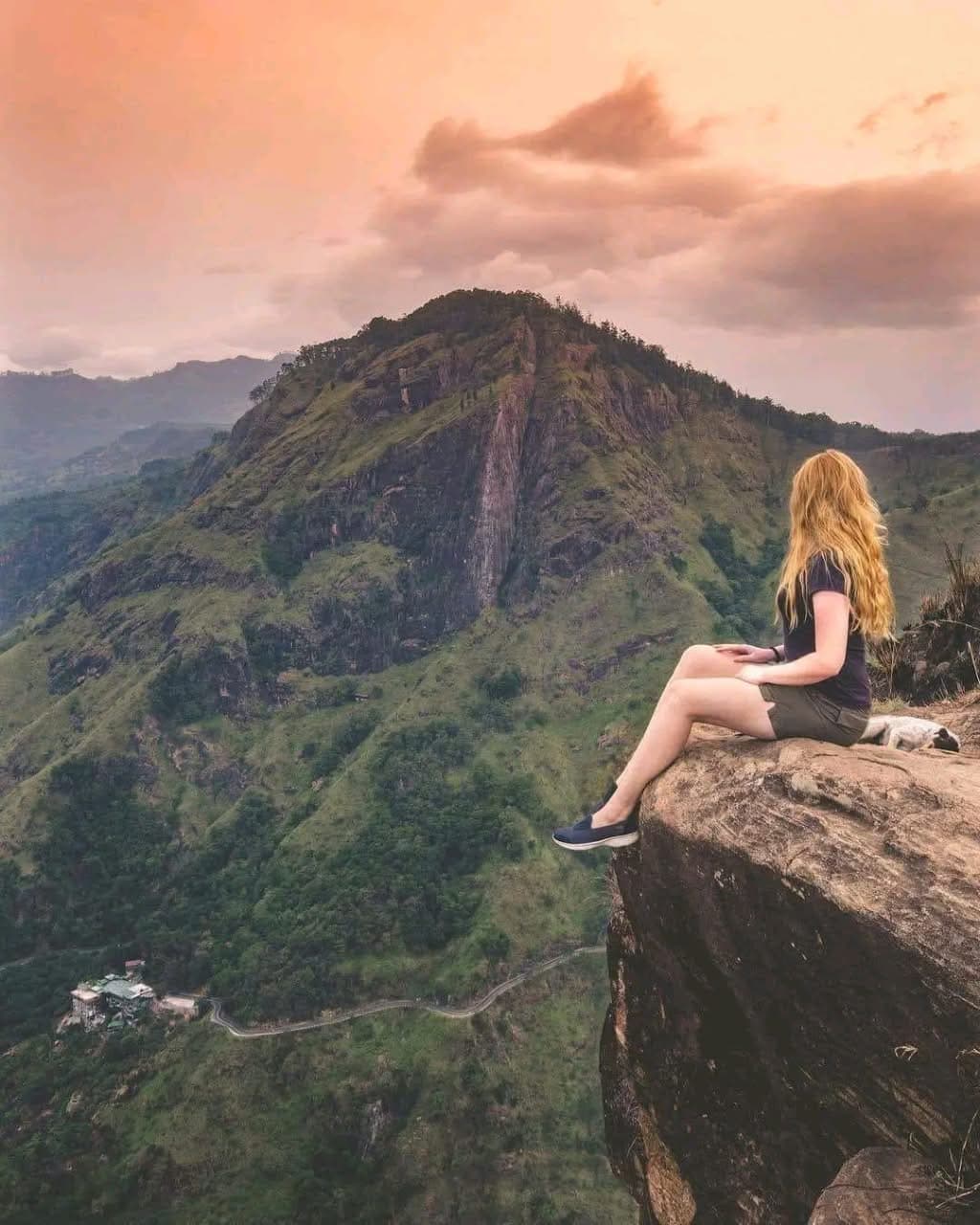 Traveller resting on a mountain summit