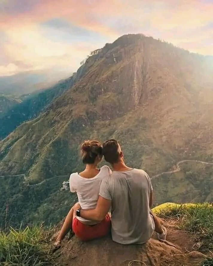 Couple taking in the view from a summit